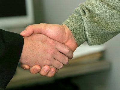 a close up of two people shaking hands