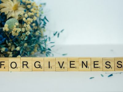 a scrabble type block spelling out the word forgiveness