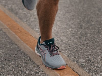 person in white nike sneakers