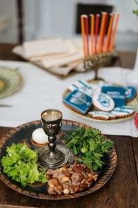 Close-up of a traditional Jewish meal with symbolic foods and a candleholder for Hanukkah.